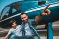 Cheerful dad talking with kid near helicopter Royalty Free Stock Photo