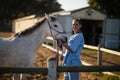 Portrait of happy vet stroking horse Royalty Free Stock Photo