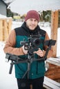 videographer man with camera mounted on gimbal stabilizer equipment in winter. Royalty Free Stock Photo