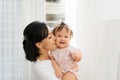 Portrait of happy vietnamese mother hugging with her cute little daughter at home Royalty Free Stock Photo