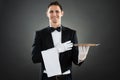 Portrait Of Happy Waiter With Empty Tray And Towel