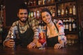 Portrait of happy waiter and waitress standing at counter Royalty Free Stock Photo