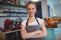 Portrait of happy waitress with arms crossed at cafe Royalty Free Stock Photo