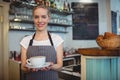 Portrait of happy waitress serving beverage at cafe Royalty Free Stock Photo