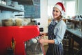 Portrait of happy waitress wearing Santa hat at cafe Royalty Free Stock Photo