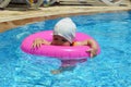 Portrait of happy white Caucasian child baby girl toddler in swimming pool outdoor. Preschool boy training to float with Royalty Free Stock Photo