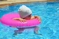 Portrait of happy white Caucasian child baby girl toddler in swimming pool outdoor. Preschool boy training to float with Royalty Free Stock Photo