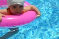 Portrait of happy white Caucasian child baby girl toddler in swimming pool outdoor. Preschool boy training to float with Royalty Free Stock Photo