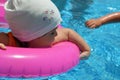 Portrait of happy white Caucasian child baby girl toddler in swimming pool outdoor. Preschool boy training to float with Royalty Free Stock Photo