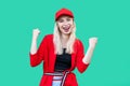 Portrait of happy winner beautiful blond young hipster style woman in red blouse and cap, standing looking at camera and Royalty Free Stock Photo