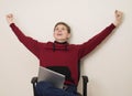 Portrait of a happy winning  young teenager boy using laptop and celebrating success isolated over white wall Royalty Free Stock Photo