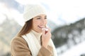 Woman applying lip balm in snowy winter