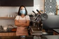 Portrait of a happy woman Asian waitress wearing a face mask and  standing at a coffee shop, Small business owner and startup with Royalty Free Stock Photo