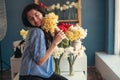 Portrait of a happy woman with a bouquet of flowers in her hands. Florist working in a flower shop Royalty Free Stock Photo