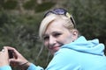 Portrait of happy woman with a camera