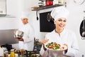 Woman chef serving fresh salad Royalty Free Stock Photo