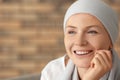 Portrait of happy woman after chemotherapy on blurred background