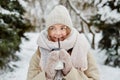 Portrait of a happy woman with a cup of hot tea. Beautiful winter park. Royalty Free Stock Photo