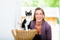 Portrait of happy woman with cute kittens in wicker basket