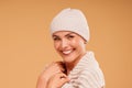 Portrait of happy woman with delicate makeup and big amazing smile, wearing beige cap and warm scarf Royalty Free Stock Photo