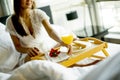 Portrait of happy woman eating breakfast in bedd hea