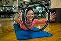 Portrait of happy woman exercising with pilates ring Royalty Free Stock Photo