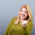 Portrait of happy woman exults pumping fists ecstatic celebrates success against gray background Royalty Free Stock Photo