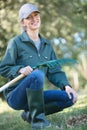 portrait happy woman gardener with tools in garden Royalty Free Stock Photo