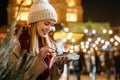 Portrait of happy woman girl eating donuts and enjoying christmas market. Holiday christmas people Royalty Free Stock Photo