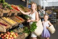 Portrait of happy woman and girl gladly shopping Royalty Free Stock Photo