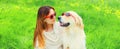 Portrait of happy woman with her Golden Retriever dog wearing sunglasses on green grass in summer park Royalty Free Stock Photo