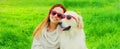 Portrait of happy woman with her Golden Retriever dog wearing sunglasses on green grass in summer park Royalty Free Stock Photo