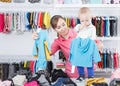 Portrait of happy woman with her kid looking clothes Royalty Free Stock Photo