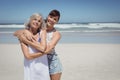 Portrait of happy woman with her mother standing at beach