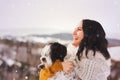 Woman and her Tibetan terrier dog on a snowy day Royalty Free Stock Photo