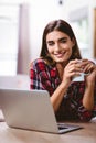 Portrait of happy woman holding coffee mug with laptop Royalty Free Stock Photo