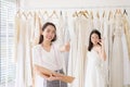 Portrait of happy woman holding credit card in wedding dress store owner,Beautiful successful dressmaker in shop and small busines Royalty Free Stock Photo