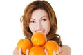 Portrait of a happy woman holding oranges Royalty Free Stock Photo