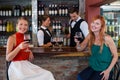 Portrait of happy woman holding a red wine glass at bar counter Royalty Free Stock Photo