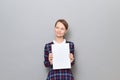 Portrait of happy woman holding white blank paper sheet in hands Royalty Free Stock Photo