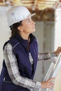 portrait happy woman on ladder with tools