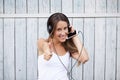 Portrait of a happy woman listen music with thumbs up Royalty Free Stock Photo