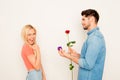 Portrait of happy woman and man holding rose and box with wedding ring Royalty Free Stock Photo