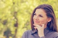 Portrait of a happy woman in park on sunny autumn afternoon. Cheerful beautiful girl in gray shirt and outdoors on beautiful fall