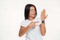 Portrait of a happy woman pointing finger at smart watch Royalty Free Stock Photo