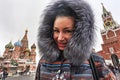 Portrait of a happy woman posing between St. Basil `s Cathedral