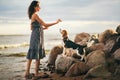 Image of happy woman 20s hugging her dog while walking along the beach Royalty Free Stock Photo