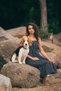 Image of happy woman 20s hugging her dog while walking along the beach Royalty Free Stock Photo