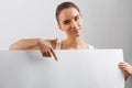 Portrait of happy woman, showing empty blank signboard with copyspace. Business Woman holding a big white banner Royalty Free Stock Photo