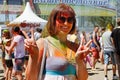 Portrait of happy woman showing victory sign on Holi color festival in Volgograd Royalty Free Stock Photo